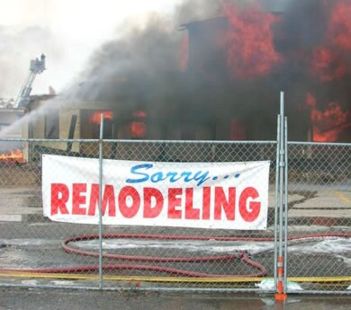 image of building on fire with a sign reading sorry remodeling